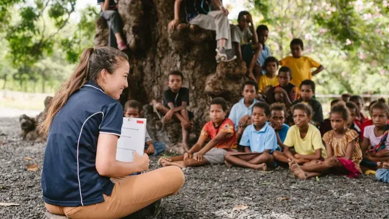 A YWAM team member teaching children during community outreach in Papua New Guinea